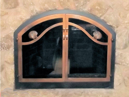 Nauset Wave Arch    Black frame, antique copper twin doors with smoked glass. Comes with gate mesh door spark screens.  (Nauset =scallop shell appliques)  (mortar installation)